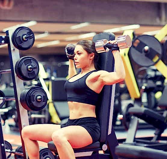 young-woman-flexing-muscles-with-dumbbell